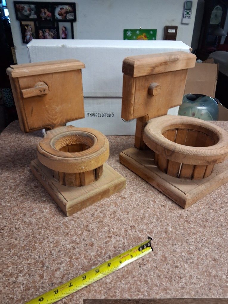 Wooden toilet bowl planters.