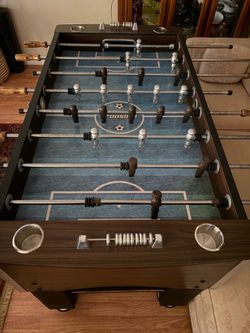 Foosball table with cup holders