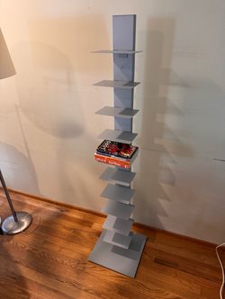 Floating spine gray vertical metal book shelf