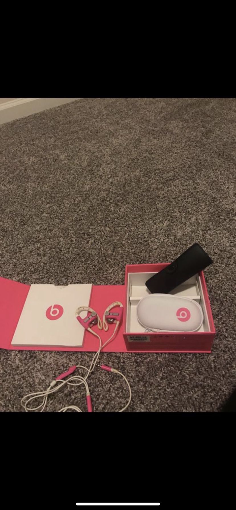 Pink and white Beats by Dr. Dre headphones