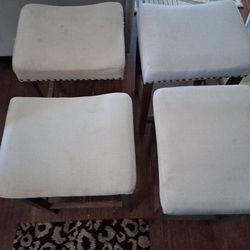 4 stools matching set cushions on for of them.Studs around the stool