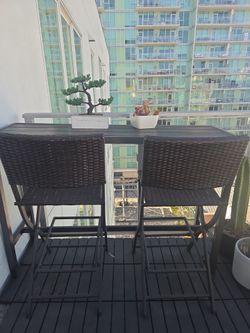 Outdoor high table with folding chairs