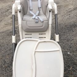Child feeding seat with detachable tray on wheels tan with working seatbelt/buckles that works