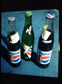 Three collectible vintage bottles of Pepsi and 7-Up