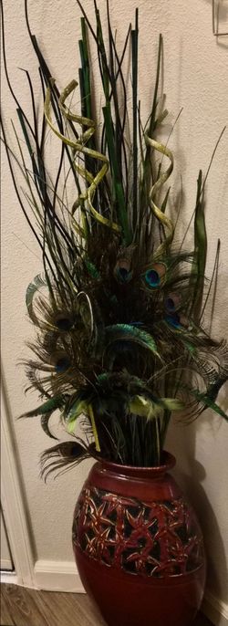 Red Ceramic Vase with Peacock Feather Arrangement