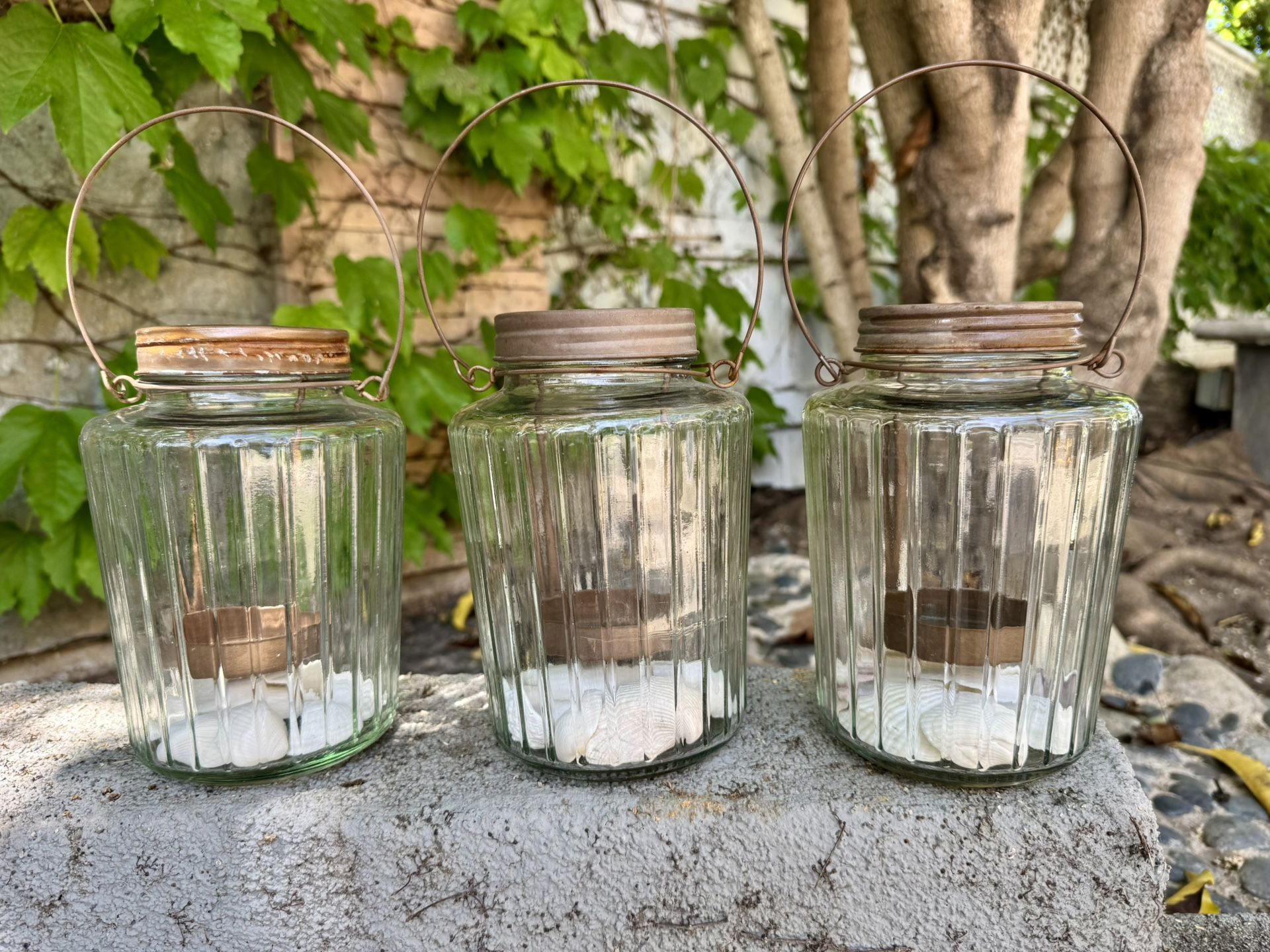 Three outdoor candle holders.