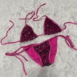 Two-piece hot pink string bikini with sequin front panels. Triangle top and tie-side bottoms. Sparkly accent for a standout beach look.  New small Hot