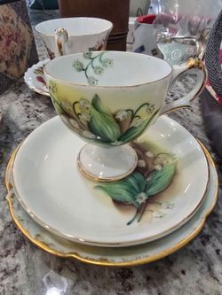 Multiple tea cups and 2 tea sets