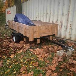 A 4 By 8 Tilt Trailer With Landscaping Equipment And Gas Powered Powerwasher 