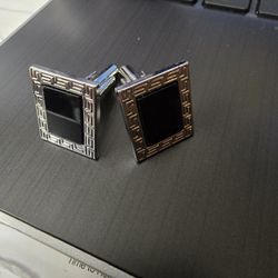 Black and silver colored cufflinks