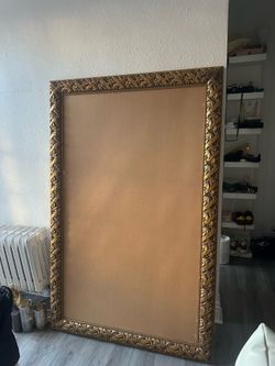 Ornate bronze/gold mirror frame