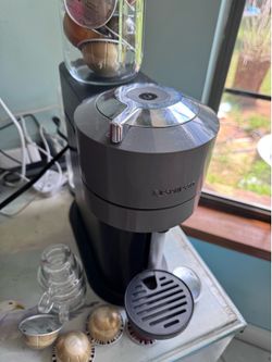 Nespresso machine with pods and cups