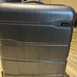 Hard case suitcase  has 4 wheels with combination lock, 3 zippers in the inside. 
