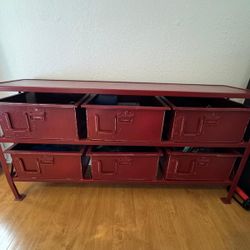 Pottery Barn storage furniture with deal for toys or tools, its made of industrial-style metal. 