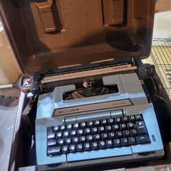 blue Smith-Corona Coronet Automatic 12 typewriter.