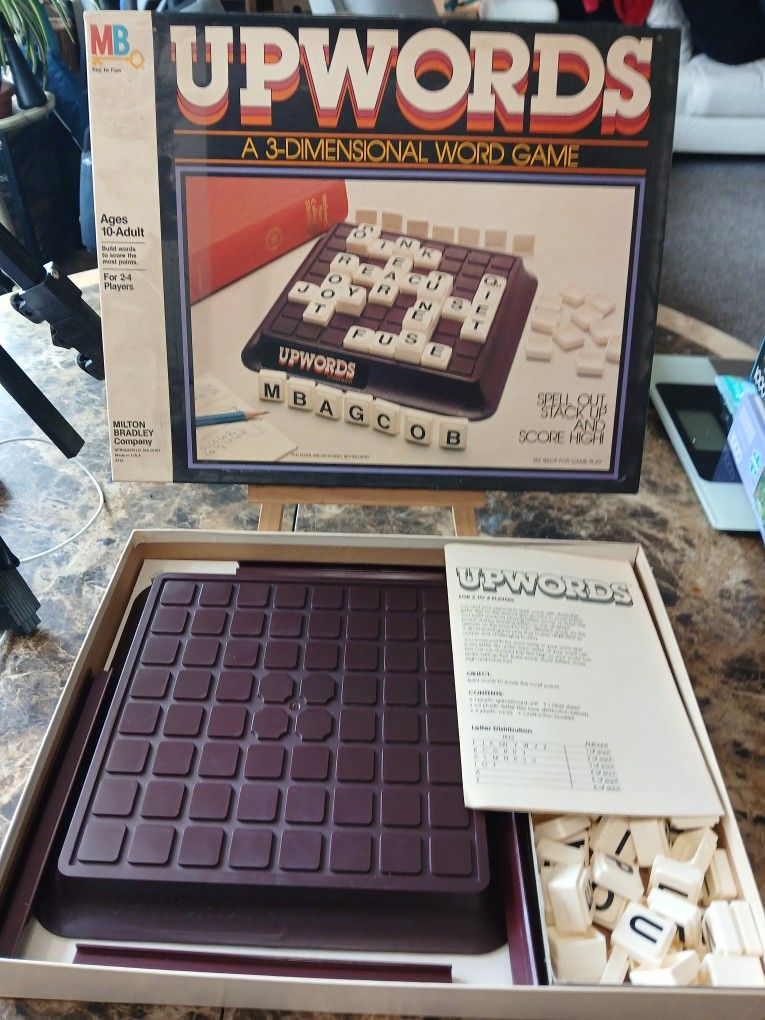 The Vintage 1983 UPWORDS Milton Bradley Board Game is a classic 3-dimensional word game that challenges players to strategize their way to high scores