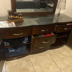 Dresser with mirror, solid wood, with glass on it to protect top, dark brown,3 drawers and shelves, great condition, perfect size, this is quality not