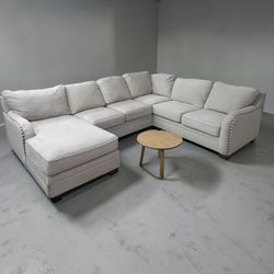 Large light grey sectional couch with chaise
