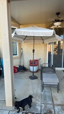 Patio umbrella with weighted stand