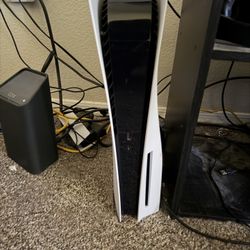 PS5 with 2 controllers and games.