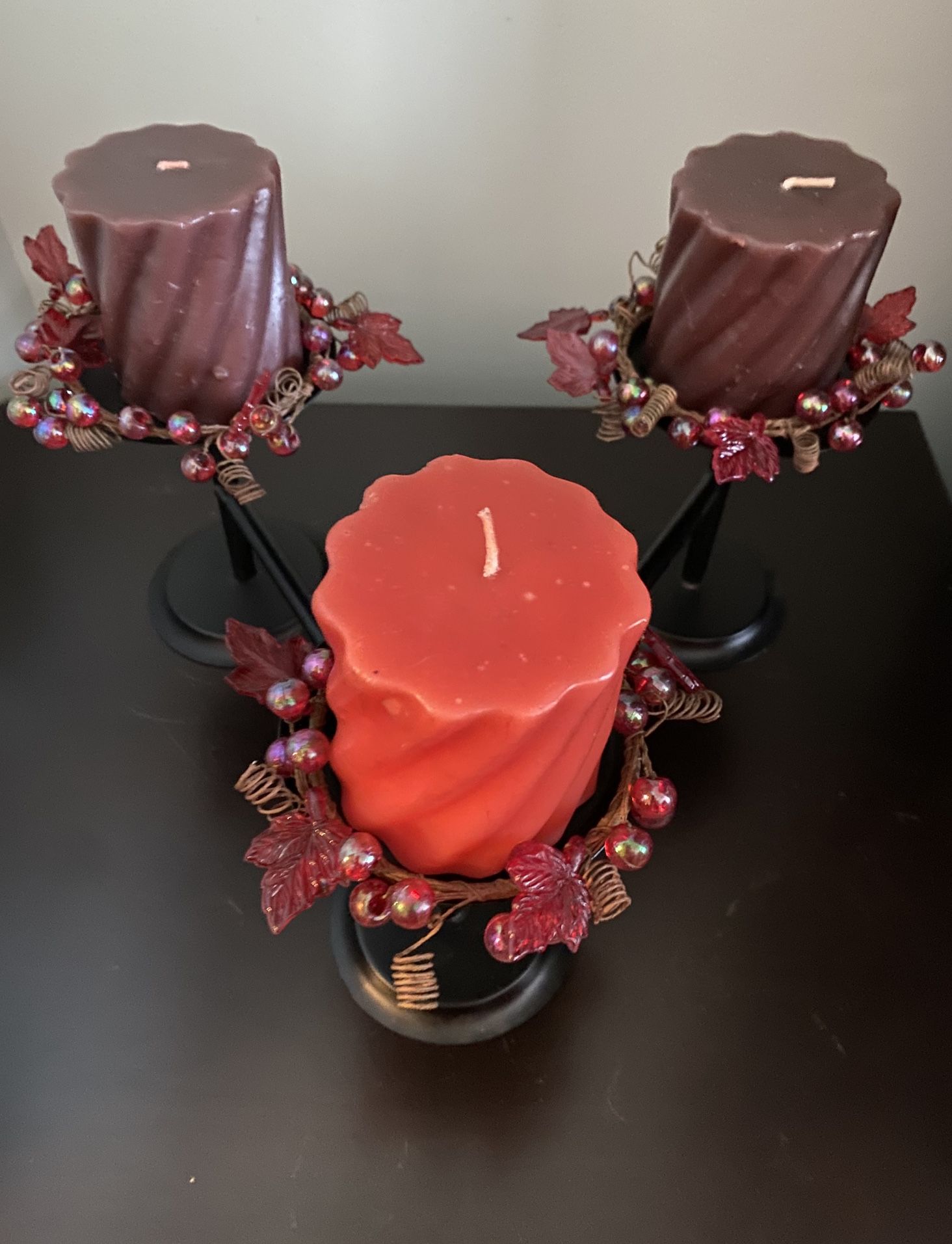 Black iron candle holder with three candles
