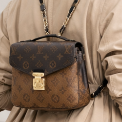 mini backpack crafted in classic brown monogram canvas with a two-tone design.