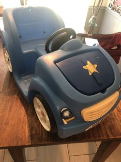 Cute toddler blue ride on car.