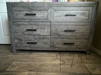 Grey wood dresser with black handles
