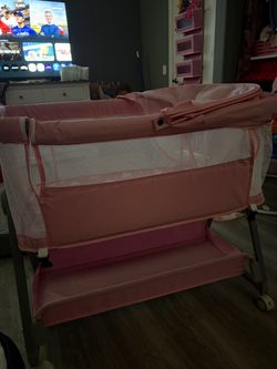 Pink bedside bassinet