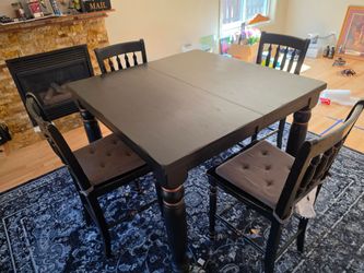 East West Furniture Chelsea set features a square black counter-height table with a self-storing butterfly leaf.