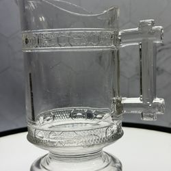 This is an antique Early American Pressed Glass (EAPG) creamer in the "Two Bands" pattern, manufactured by Doyle & Co. or LaBelle & Co. around the 188