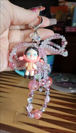 handmade beaded keychain or phone charm featuring a Skullpanda figure.