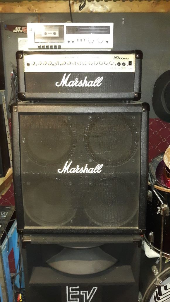 100 watt Marshall amp and 4x12" slanted speaker cabinet or half stack.