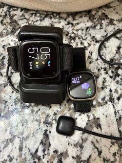 Two Fitbit Smartwatches with Charging Cables