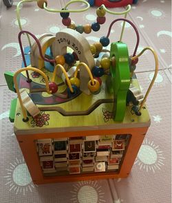 Wooden activity cube for toddlers