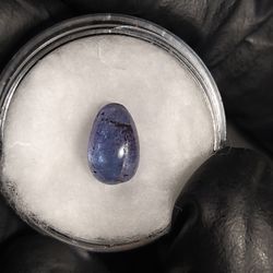Natural Deep Blue Tanzanite Cabochon in display 