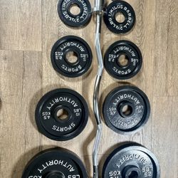 Beautiful  Equipment: Curl Bar W/Cooper Bearings & Pair of Weight Plates 25s, 10s, 5s And 2.5 Pounds. (Total: 105 lbs)  