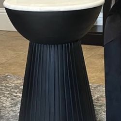 Two black hourglass black marble tables