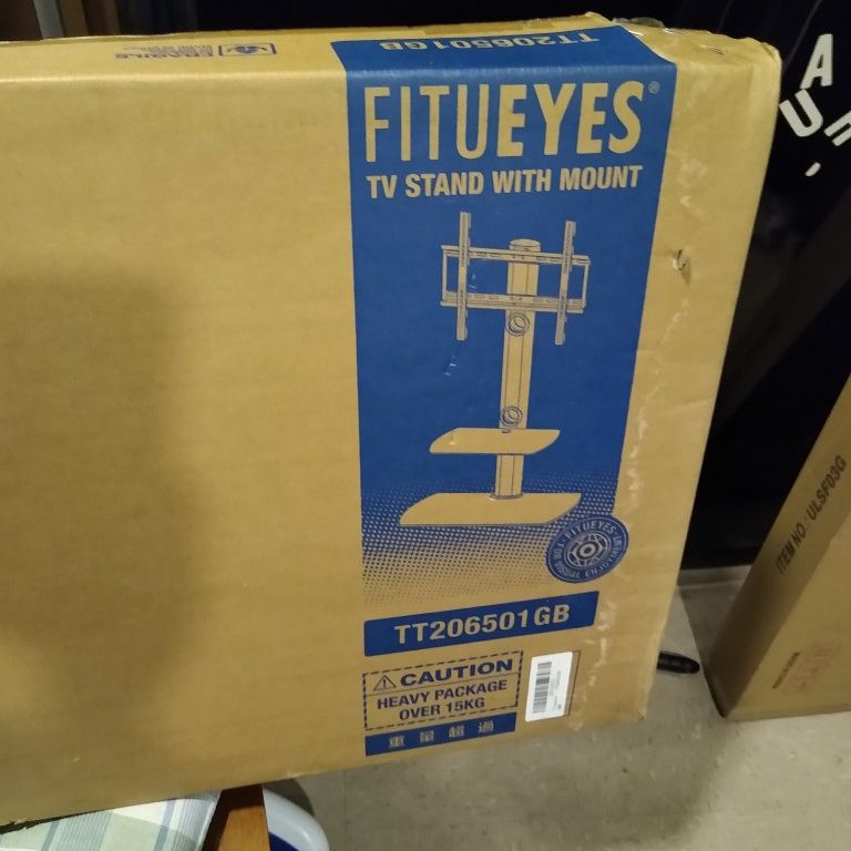 FITUEYES Brand Tv Stand With Mount Swivels And Has 2 Glass Shelves. Stand weighs 35lbs.