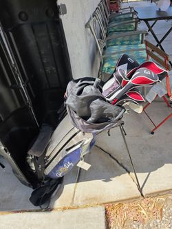 Golf clubs with hard case and dolly.