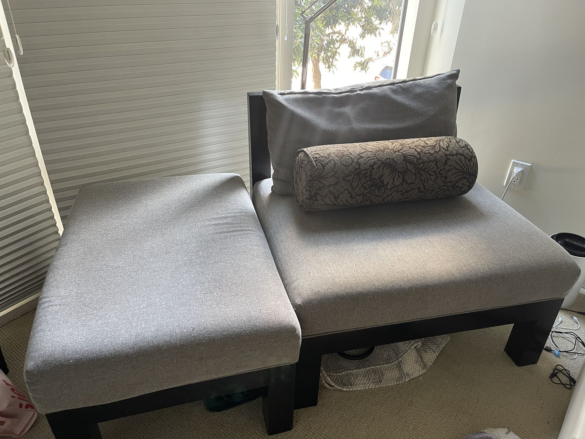 Cushioned Grey Chair With Foot Rest And Pillows