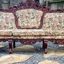 Gorgeous Antique Victorian Sofa with ornately carved wood accents.