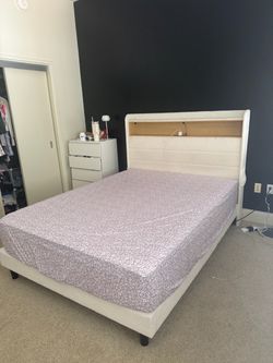 Queen bed frame with storage on top with outlets. Beautiful and soft.