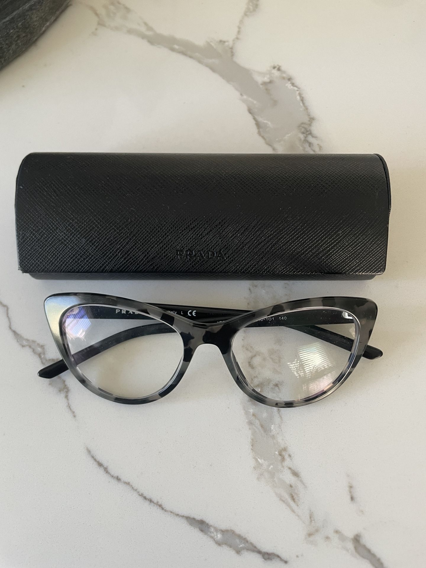 Authentic Prada  black and gray tortoise cat-eye frame eyeglasses, model VPR 05X 510-101, made in Italy. 