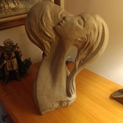 Sculpture pictured is the faces of love by David Fisher pottery sculpture 1980.