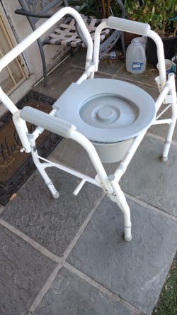 White chair. Portable toilet.  Good condition  $. 55.   ...