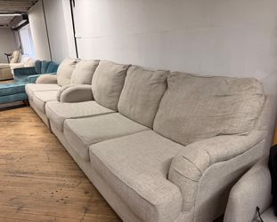 Delivery Available Beige sofa/ couch w pull out bed