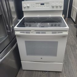 GE stove new condition warranty ready to deliver baige glasstop convention warranty..301 saundview ave bronx NY 10473..LJP appliances..$425