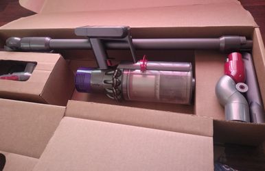 That is a Dyson V10 Animal+ cordless stick vacuum.
The label in your photo identifies it as:
Model: SV27
Version: Animal+
Dyson Factory Certified Re