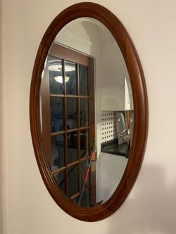 Large heavy wooden oval beveled mirror